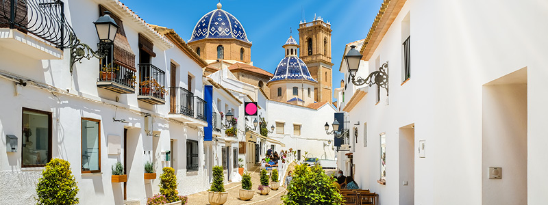 Kuststaden Altea p Costa Blanca i Spanien - till vnster uppe p en kulle i Gamla stadsdelen och till hger bild p kyrkan Nuestra Senora del Consuelo.