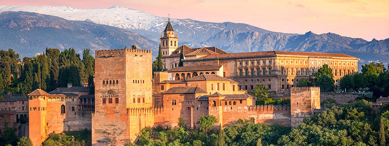 Morerpalatset Alhambra bland skog och snöklädda berg i Granada, Andalusien.